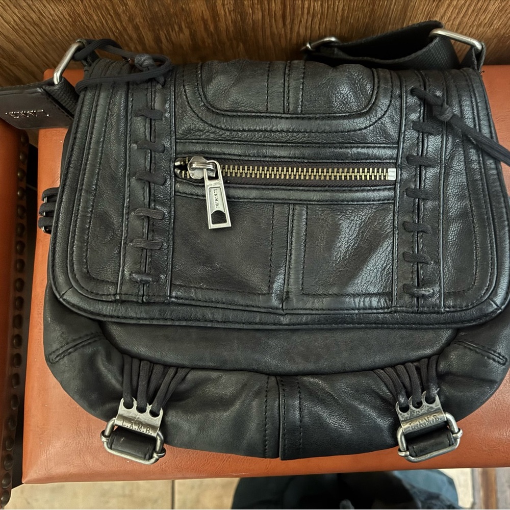 Black Leather Women’s Crossbody bag with lace up detail.